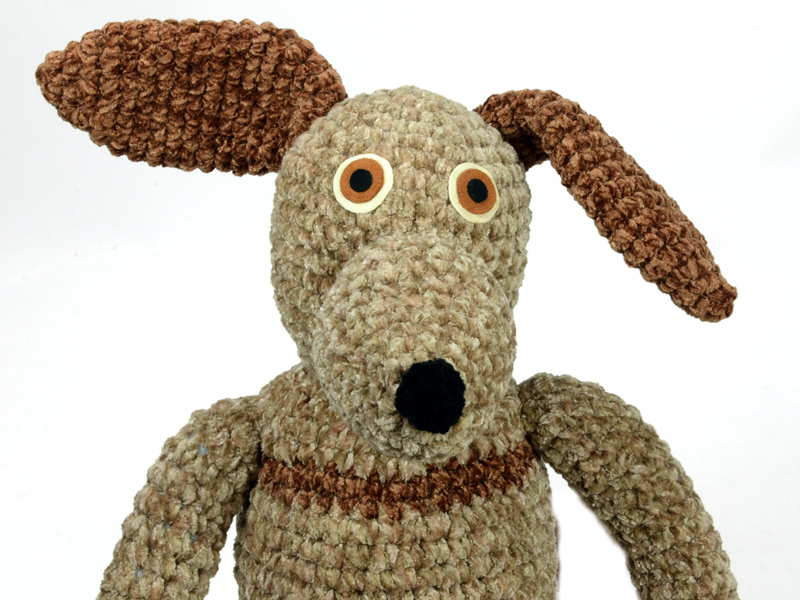 Handmade crocheted striped dog.